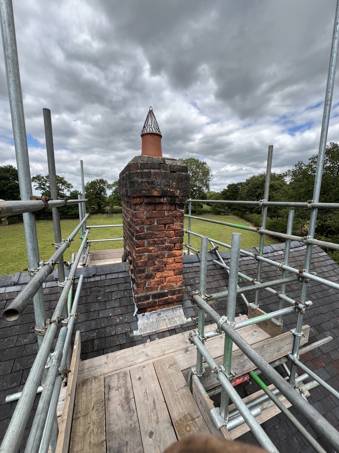 Working platforms and guardrails around a brick chimney on the Arley Hall estate