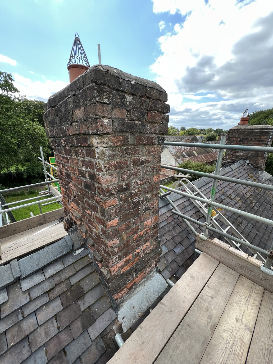 Close view of a chimney and the surrounding scaffold platforms on the Arley Hall estate
