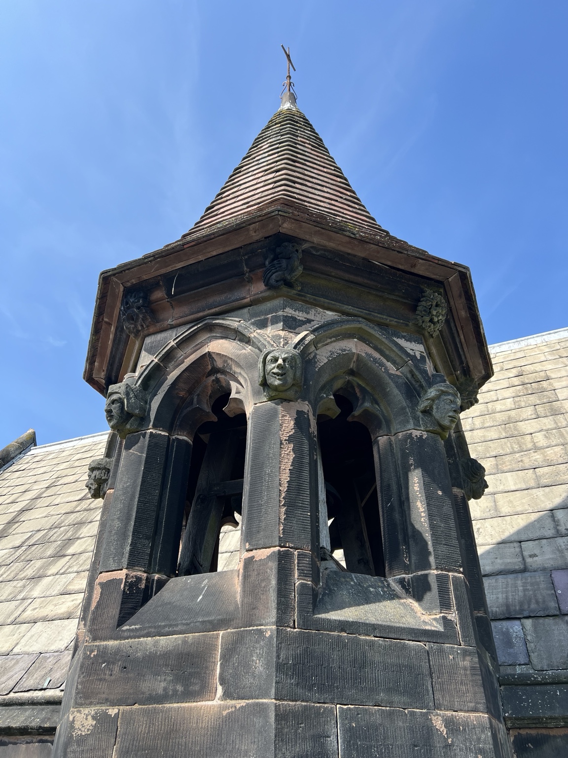 Carved stone faces and a tiled spire on the Arley Hall estate