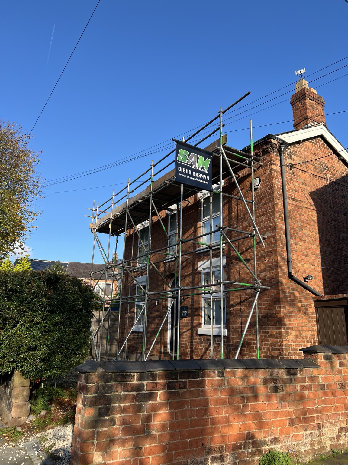 Scaffolding for re-roofing a brick house in Barnton